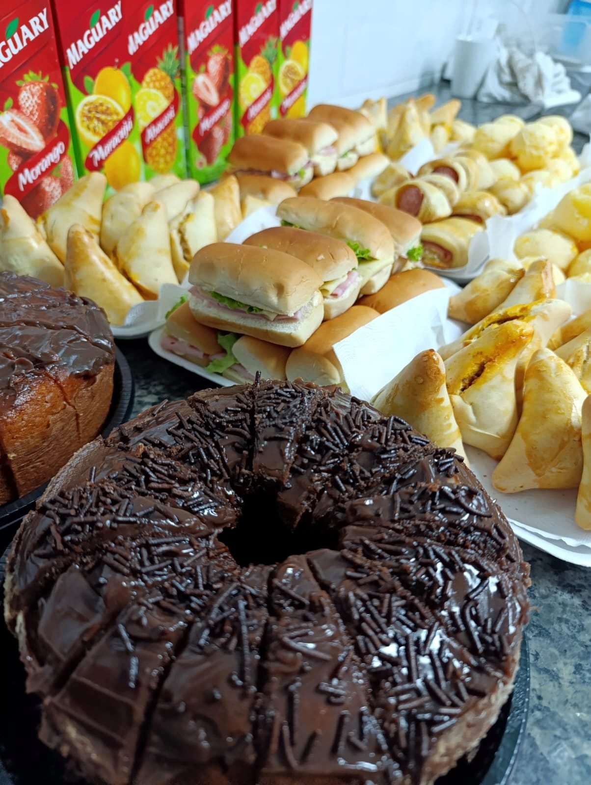 Bolo de chocolate e variedade de itens para coffee break